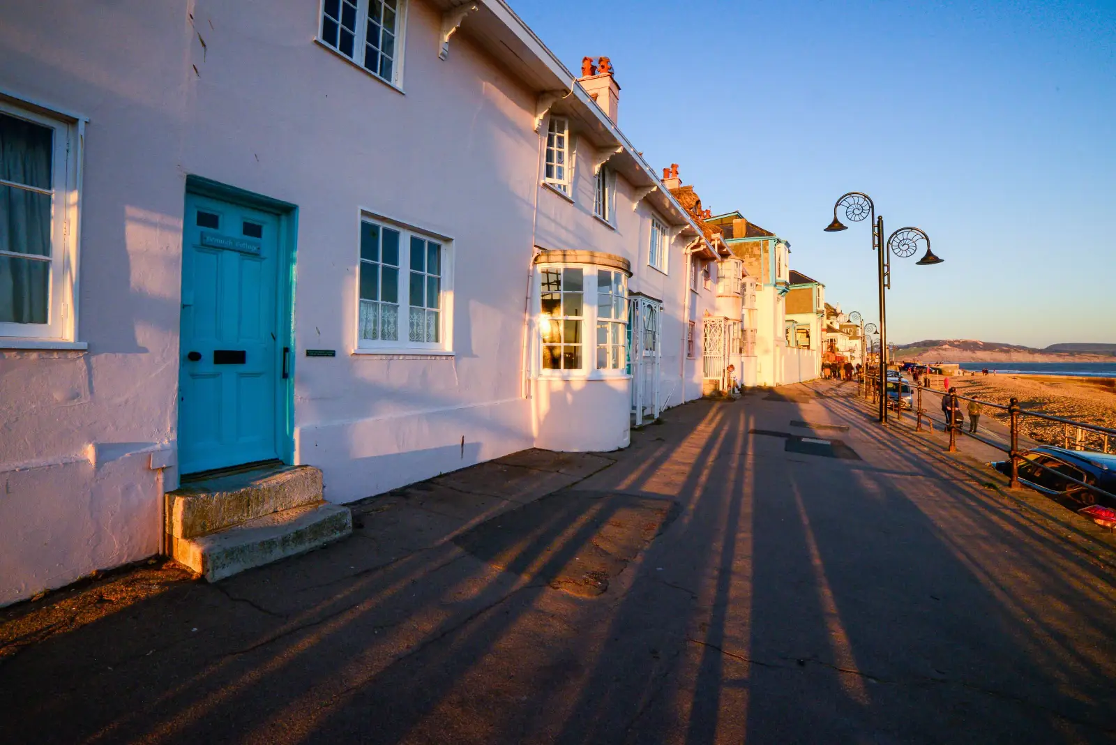 Row of period seafront cottages in evening sunlight